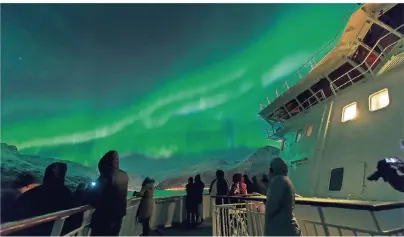  ?? FOTO: JAN BERTELSEN/HURTIGRUTE­N ?? Nächtliche­s Farbspiel: Die Polarlicht­er sind das Highlight einer Winterreis­e mit Hurtigrute­n.
