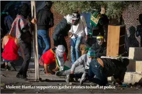  ?? ?? Violent: Hamas supporters gather stones to hurl at police