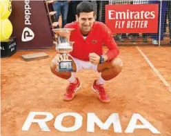  ?? Agence France-presse ?? ↑
Serbia’s Novak Djokovic celebrates with the trophy after winning the final match against Greece’s Stefanos Tsitsipas at the Italian Open.