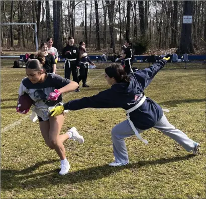  ?? COURTESY PHOTO ?? Greater Lowell Tech flag football player Alexis Peralta, left, motors past a teammate during a recent practice session.