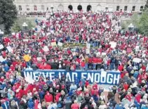  ?? SUE OGROCKI/ASSOCIATED PRESS (LEFT); ALEX SLITZ/LEXINGTON HERALD-LEADER ?? On Monday, teachers protest low school funding at the state Capitol in Oklahoma City, while thousands rally at the Kentucky Capitol in Frankfort.