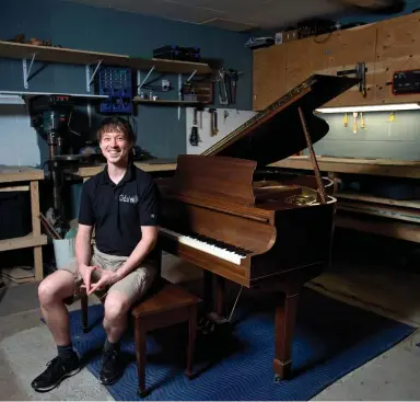  ??  ?? Mitch Oxford poses with a Mason &amp; Risch baby grand piano that he restored at his workshop near Guelph.