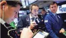  ??  ?? Traders work on the floor of the New York Stock Exchange on Thursday. JUSTIN LANE/EPA-EFE