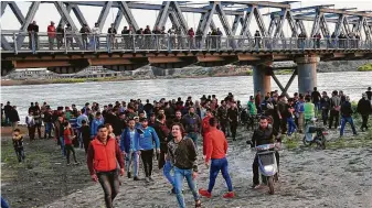  ?? Farid Abdulwahed / Associated Press ?? Onlookers and relatives of victims wait on the bank of the Tigris river where a ferry sank in Mosul, Iraq, on Thursday, killing dozens of people, mostly women and children, authoritie­s said.