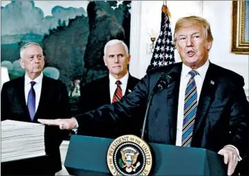  ?? MARK WILSON/GETTY ?? President Trump, with Defense Secretary Jim Mattis, left, and Vice President Mike Pence, points to the spending bill.