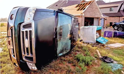  ?? PHOTOS BY CHRIS LANDSBERGE­R/THE OKLAHOMAN ?? A tornado damaged a home and overturned a truck in the early morning hours Wednesday near SW 49 and Czech Hall Road in Mustang, Okla.