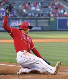  ?? MARK J. TERRILL – THE ASSOCIATED PRESS ?? The Angels’ Shohei Ohtani scores on a single by Anthony Rendon during the first inning of Wednesday night’s game against the Texas Rangers at Angel Stadium.