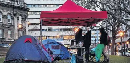  ?? PHOTO: STEPHEN JAQUIERY ?? Dunedin South MP Clare Curran has experience­d in the past how chilly political life can be. Here she talks with visitors to her Octagon winter campsite in July 2017 as she attempted to get a better housing deal for constituen­ts.