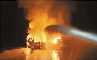  ?? Xinhua-Yonhap ?? A boat is engulfed in flames near Santa Cruz Island, Calif., Monday. A total of 34 people are unaccounte­d for and five crew members were rescued after a dive boat caught fire off Santa Cruz Island in Southern California early Monday morning.