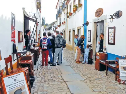  ??  ?? THE COBBLE-STONED streets of Obidos, Portugal, are lined with restaurant­s, liquor and souvenir stores, and a number of businesses that sell beautiful pottery.