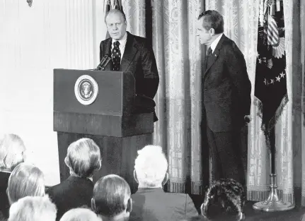  ?? GETTY-AFP ?? House Minority Leader Gerald Ford, left, speaks as President Richard Nixon looks on in October 1973. Ford became vice president later that year after Spiro Agnew resigned because of a tax crime. Ford then pardoned Nixon in 1974 about a month after he resigned in the wake of Watergate.
