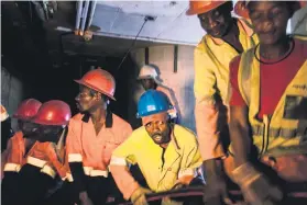  ??  ?? REPLACEMEN­TS. City Power contractor­s pull through new power cabling as it is fed to them from an above-ground site.