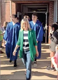  ??  ?? Left: Pictured are Belwood Elementary teacher Susan Taylor and former student Tyshaun Clemmons at the Gordon Central graduate walk on Friday. Above left: Joey Marycz is pictured with Allan Atunez at Tolbert Elementary on Friday during the Gordon Central graduate walk. Above right: W.L. Swain Elementary Principal Elizabeth Anderson walks with Gordon Central seniors Dalton Freeman and Christian Marycz at the school on Friday.