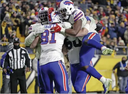  ?? DONWRIGHT ?? Buffalo Bills tight end Tyler Kroft (81) celebrates with running back Devin Singletary (26) and others after scoring on a pass from quarterbac­k Josh Allen during the second half of an NFL football game against the Pittsburgh Steelers in Pittsburgh, Sunday.