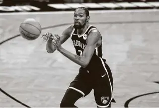  ?? Kathy Willens / Associated Press ?? Kevin Durant got his first chance to play alongside close friend Kyrie Irving with the Nets, scoring 15 points in just under 24 minutes in a preseason game against the Wizards on Sunday.