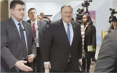  ?? AP FILE PHOTO ?? POLITICAL THREATS: Mike Pompeo, President Trump’s nominee for Secretary of State, center, walks to an elevator after a meeting with Sen. Angus King (I-Maine) on Capitol Hill earlier this month.