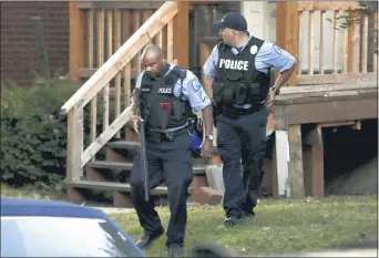  ?? DAVID CARSON — THE ASSOCIATED PRESS ?? Members of the St. Louis Police Department work near the scene of the shooting Saturday that took the life of Tamarris L. Bohannon.