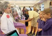  ?? Kristina Wilder / Rome News-Tribune ?? Wyatt Nance as Albert Einstein speaks to fellow Darlington students Alex Childers (center) and Callie Eady.