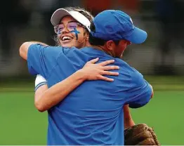  ?? Jason Fochtman / Staff photograph­er ?? Barbers Hill pitcher Samantha Landry celebrates with coach Aaron Fuller after limiting Hallsville to a hit with 12 strikeouts to advance to the 5A title game.