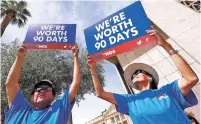  ?? MATT YORK/ASSOCIATED PRESS ?? Roger Parrish and Diane Johnson, right, rally Wednesday outside the Capitol in Phoenix.