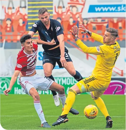  ??  ?? Andy Boyle heads in the opening goal for Dundee at Hamilton