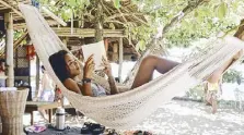  ??  ?? Just hanging out: The hammocks in the yoly House are the best place to read on the island.