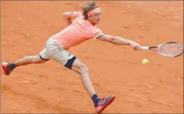  ?? The Associated Press ?? Germany’s Alexander Zverev returns a shot against Damir Dzumhur during third-round action of the French Open in Paris, France, on Friday.