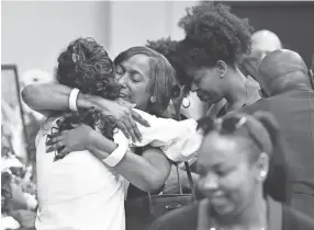  ??  ?? Shirl Baker receives hugs Saturday from well wishers before the funeral of her daughter DeEbony Groves, who was killed in the Antioch Waffle House shooting. LARRY MCCORMACK / THE TENNESSEAN