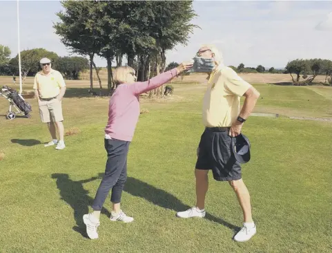  ??  ?? Selsey’s lady captain gives her veteran counterpar­t a friendly and very gentle swipe to signal the start of the Silver Gauntlet challenge