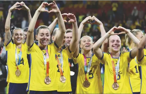  ?? TERTIUS PICKARD/AP ?? SWEDEN gesture to supporters as they celebrate with their bronze medals after defeating Australia in the Women’s World Cup third place playoff soccer match in Brisbane, Australia, on Saturday.