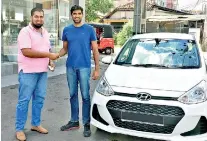  ??  ?? From left: Hyundai Lanka official Shiraz Thowfeek hands over the 500th Grand i10 to a lucky customer