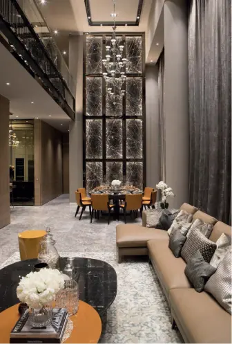  ??  ?? LEFT TO RIGHT The interior concept places emphasis on the lofty heights of the penthouse with twin Barovier & Toso chandelier­s and a full-height feature wall; built-in lighting draws attention to beautiful veins of the marble feature wall