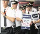  ?? EMILY JENKINS / EJENKINS@AJC.COM ?? Delta pilots conduct informatio­nal picketing recently at Hartsfield-Jackson Atlanta Internatio­nal Airport.