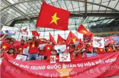  ??  ?? SEOUL: Vietnamese protesters hold their national flags, anti-China placards and a banner that reads: “We oppose China because they escalate tensions on the waters of the South China Sea” during a rally against China near the Chinese Embassy. — AP