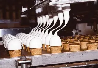  ?? Coley Brown / New York Times ?? The Drumstick ice cream cone production line churns out the Nestle product recently in Bakersfiel­d, Calif. Many items made with lower fat and sugar content are now being retooled by food makers as definition­s of what’s healthy change.
