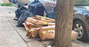  ?? KARA KNEIDL/AP ?? Trash rests piled up on a street Tuesday in the Kensington neighborho­od of Philadelph­ia. The COVID-19 pandemic has frustrated efforts to keep Philadelph­ia’s streets clear of garbage this summer. Residents complain about the stink and the flies.