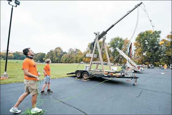  ?? ANDY LAVALLEY/POST-TRIBUNE PHOTOS ?? Pastor Andy Wenthold and his son, Nathan, watch as his machine, Medevil Mayhem, does its thing Saturday in the 9th annual Pumpkin Launch.