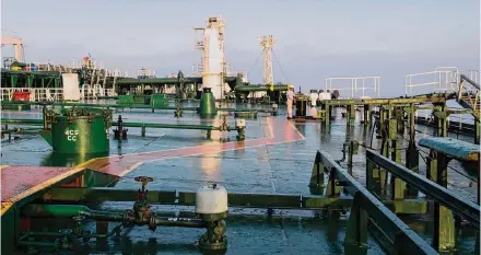  ?? Ali Mohammadi/Bloomberg file photo ?? A crewman handles an oil drum aboard an oil tanker in 2018. According to the latest data published by OPEC, Saudi Arabia’s production cuts will lead to a global oil supply shortfall of more than 3 million barrels a day next quarter.