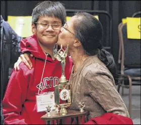  ?? HENRY TAYLOR / HENRY.TAYLOR@AJC.COM ?? Abhiram Kapaganty’s mother kisses him on the cheek after the concluding 23rd round of the Georgia Spelling Bee where Abhiram came out as the victor in Atlanta. Abhiram will represent the state in the national competitio­n.