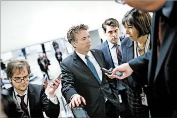  ?? WIN MCNAMEE/GETTY ?? Sen. Rand Paul, R-Ky., makes his way Thursday to the Senate floor, where he blocked a planned budget vote.