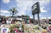  ?? AP ?? A memorial outside the Pulse nightclub in Orlando a month after the mass shooting there. Sixty-three percent of those polled called mass shootings important news.