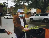  ?? JESSIE WARDARSKI — THE ASSOCIATED PRESS ?? Holocaust survivor Leon Sherman holds a lulav, a collection of palm, myrtle and willow branches, and an etrog, a citrus fruit, as he recites the blessings in front of his home in the Queens borough of New York, Monday.