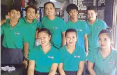  ??  ?? Marlo Gabasan, co -owner of Lugaw Network (standing, third from left) with his staff.