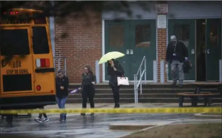  ?? ALEX BRANDON — THE ASSOCIATED PRESS ?? Teachers and school employees depart Great Mills High School, the scene of a shooting, Tuesday in Great Mills, Md. A teenager wounded a girl and a boy inside his Maryland high school Tuesday before an armed school resource officer was able to...