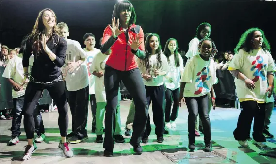  ?? GETTY IMAGES ?? Michelle Obama dances with schoolchil­dren during an exercise program in 2013. Studies consistent­ly point to the positive relationsh­ip between regular exercise and learning.