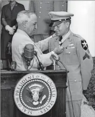  ?? U.S. ARMY PHOTO ?? President Harry S. Truman presents the Medal of Honor to Ronald Rosser in a ceremony in the White House Rose Garden in June 1952.