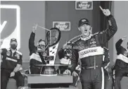  ?? [AP PHOTO/RALPH FRESO, FILE] ?? Austin Cindric celebrates in Victory Lane with the series championsh­ip trophy after winning the NASCAR Xfinity Series auto race Nov. 7 at Phoenix Raceway in Avondale, Ariz. Cindric solidified his standing at Penske by winning six races last year and his first Xfinity Series championsh­ip.