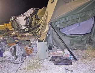  ?? SPC. DEREK CUMMINGS/U.S. ARMY VIA AP ?? A tent that was blown down by a helicopter, injuring 22 people, Wednesday at the Fort Hunter Liggett military base in California. A U.S. Army UH-60 Blackhawk helicopter was landing at about 9:30 p.m. when the wind from its rotor caused the tent to...