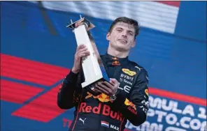  ?? (AFP) ?? Red Bull Racing’s Dutch driver Max Verstappen celebrates on the podium after winning the Miami Formula One Grand Prix at the Miami Internatio­nal Autodrome in Miami Gardens, Florida, on Sunday.