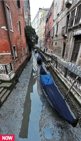  ??  ?? High and dry: Gondolas lie motionless in the muddy canals NOW